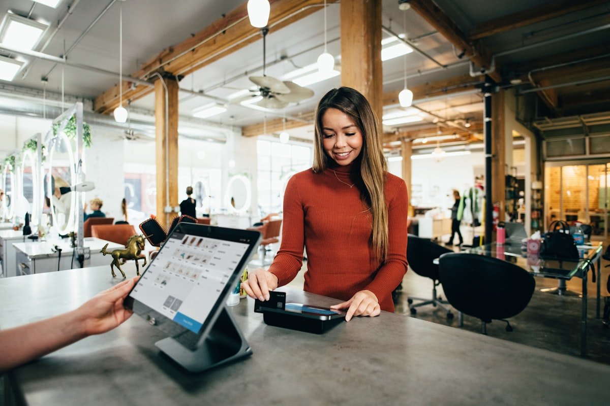 Small business owner packing an order in a bright workshop